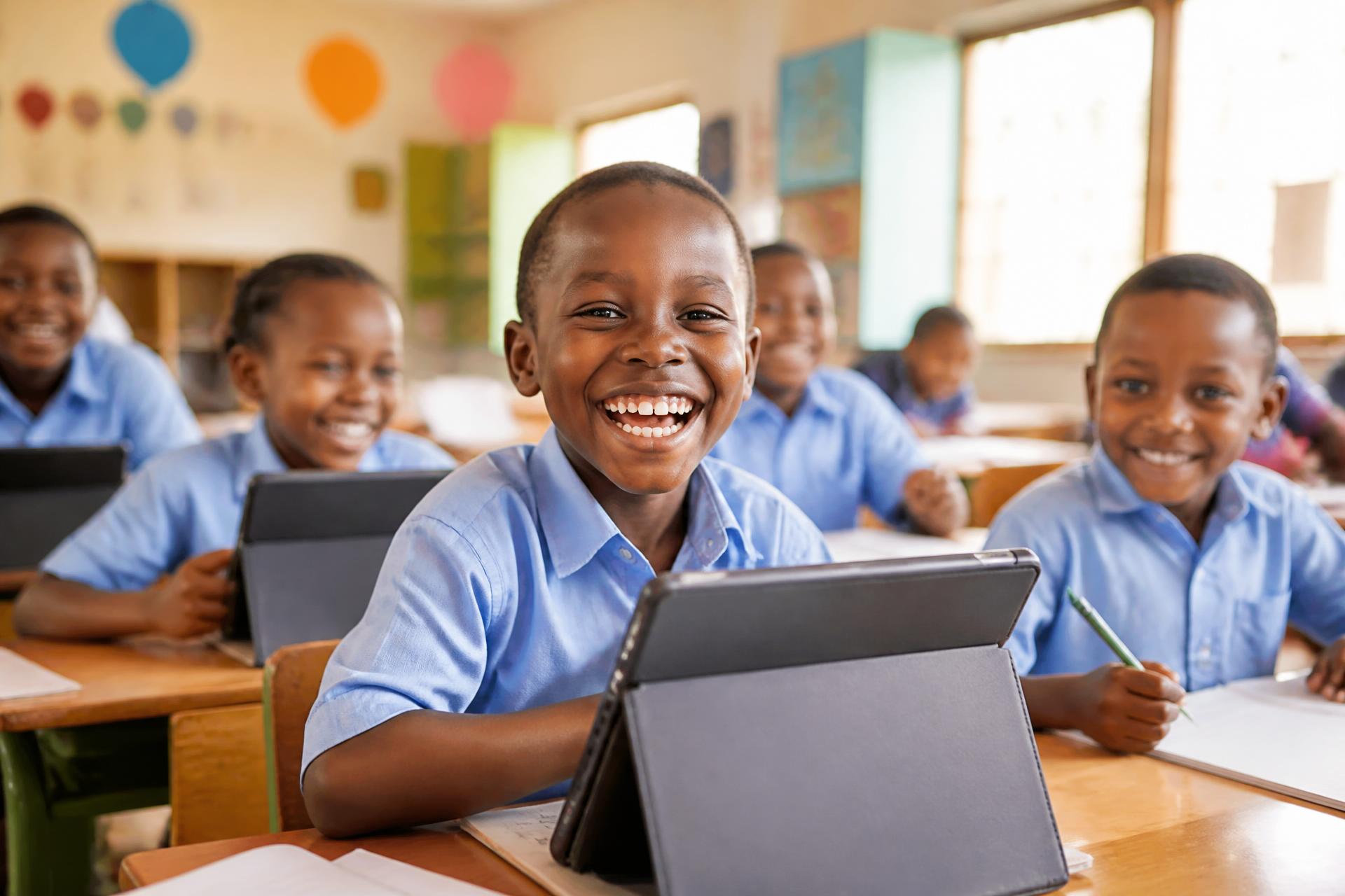 Kenyan primary school learners smiling during a lesson